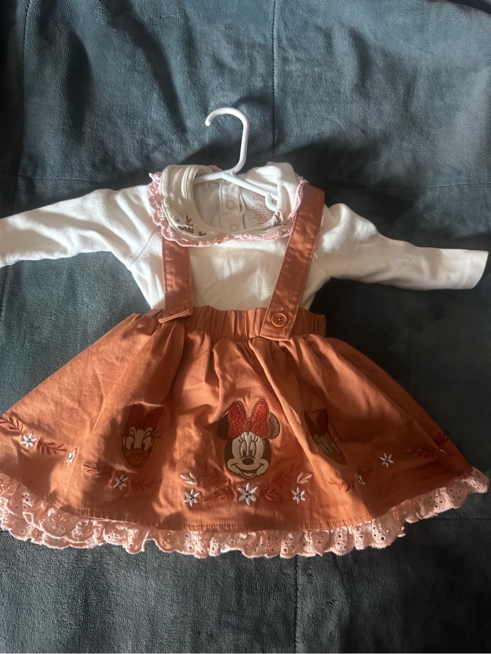 Disney Baby Cream Bodysuit with Rust Logo and Stitching